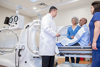 A doctor speaking with a patient before their MRI scan