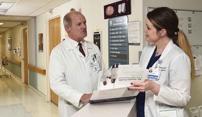 Two doctors speaking in the hallway