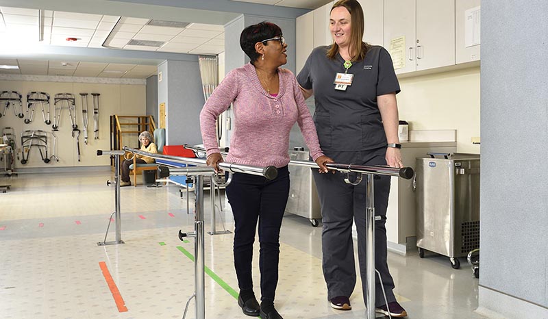 A patient in physical therapy with a nurse
