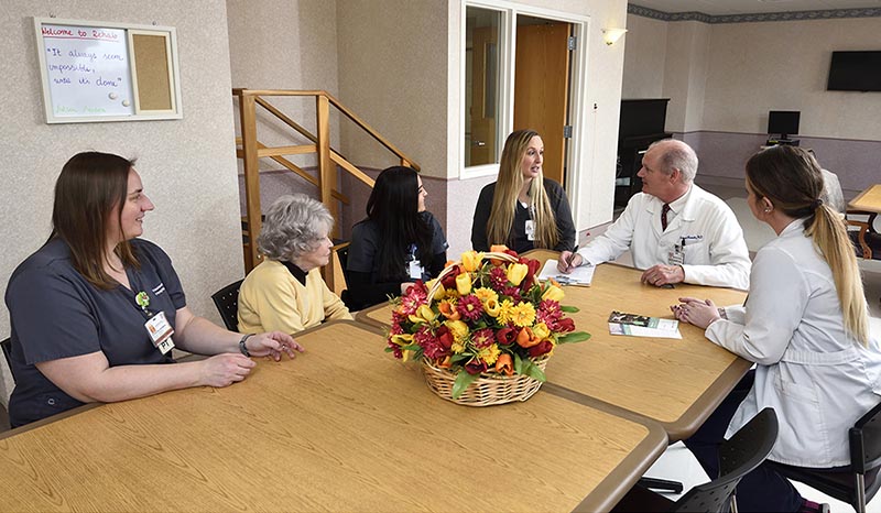 Faculty gathered together in the employee dining room